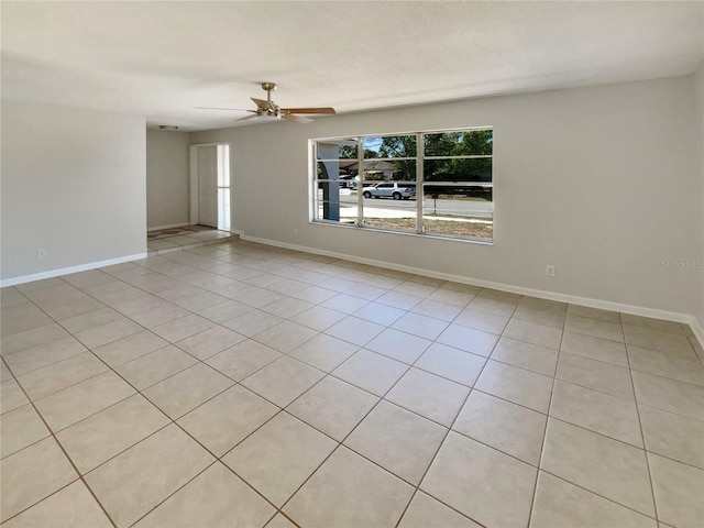 empty room with baseboards and ceiling fan