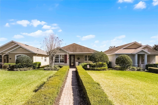 view of front of house with stucco siding and a front lawn