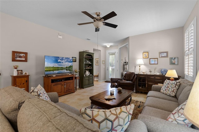 living area featuring light tile patterned flooring, visible vents, and a ceiling fan