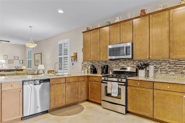 kitchen featuring a sink, brown cabinets, and stainless steel appliances