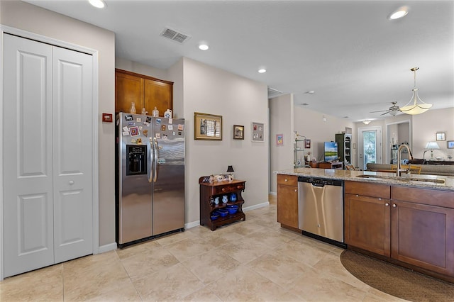 kitchen featuring visible vents, ceiling fan, open floor plan, appliances with stainless steel finishes, and a sink