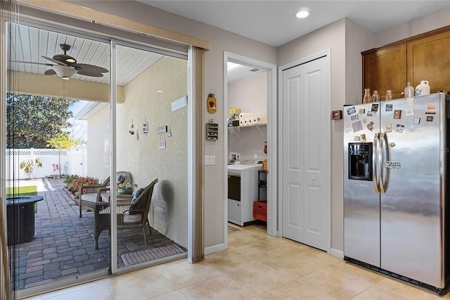 kitchen with baseboards, ceiling fan, stainless steel fridge with ice dispenser, light tile patterned flooring, and washer / clothes dryer