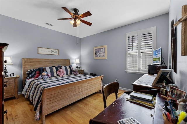 bedroom with visible vents, ceiling fan, baseboards, and wood finished floors