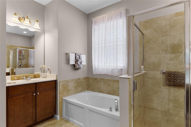 bathroom featuring vanity, a garden tub, and a shower stall