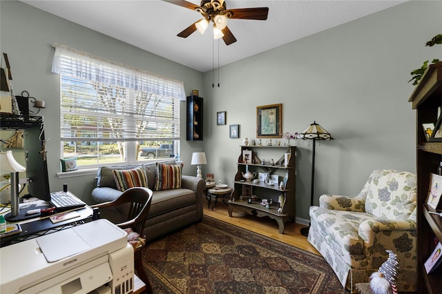 office area with a ceiling fan and wood finished floors