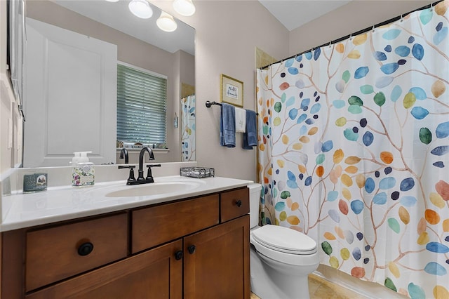 bathroom featuring curtained shower, toilet, and vanity