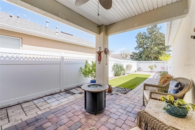 view of patio / terrace with a fenced backyard, central AC unit, and ceiling fan