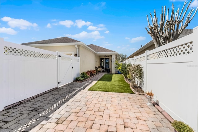 view of patio / terrace with a fenced backyard and a gate