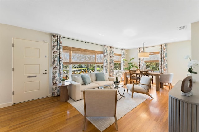 living room featuring visible vents and light wood-type flooring