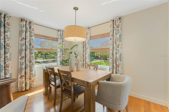 dining area featuring baseboards and wood finished floors