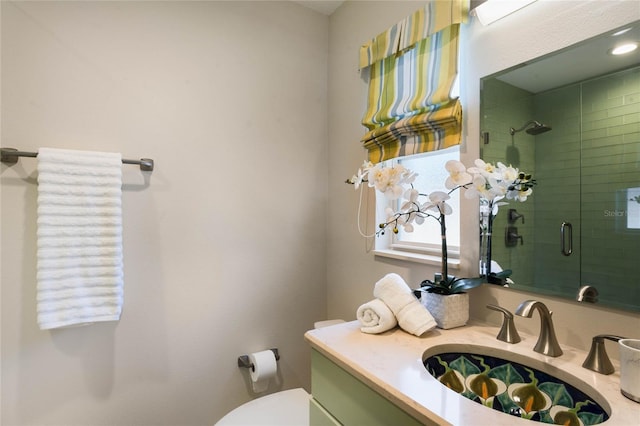 full bathroom with vanity, a shower stall, and toilet