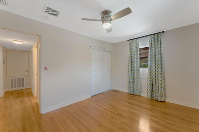 unfurnished bedroom with light wood-style flooring, baseboards, and visible vents