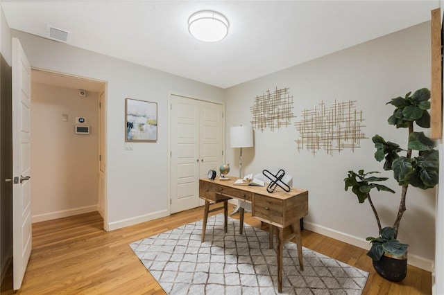 office with visible vents, light wood-style flooring, and baseboards