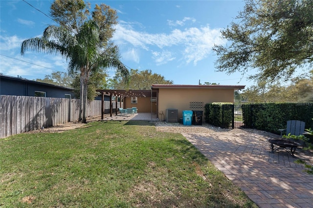 view of yard with cooling unit, a fenced backyard, a pergola, and a patio area