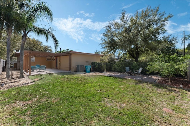 view of yard featuring central air condition unit, a patio, and a fenced backyard