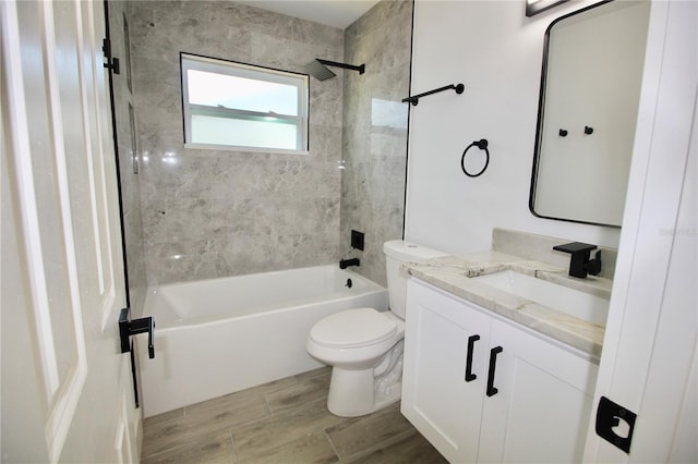 bathroom featuring vanity, bathing tub / shower combination, toilet, and wood finish floors