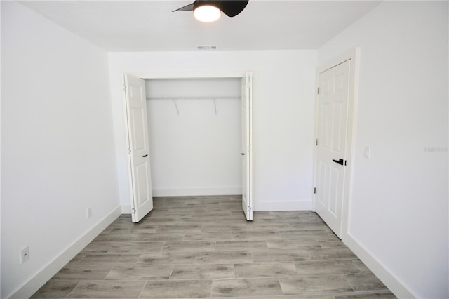 unfurnished bedroom with visible vents, baseboards, ceiling fan, light wood-style floors, and a closet