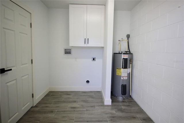 laundry room with water heater, cabinet space, hookup for an electric dryer, and wood finish floors