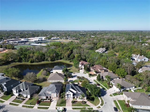 aerial view with a wooded view, a water view, and a residential view