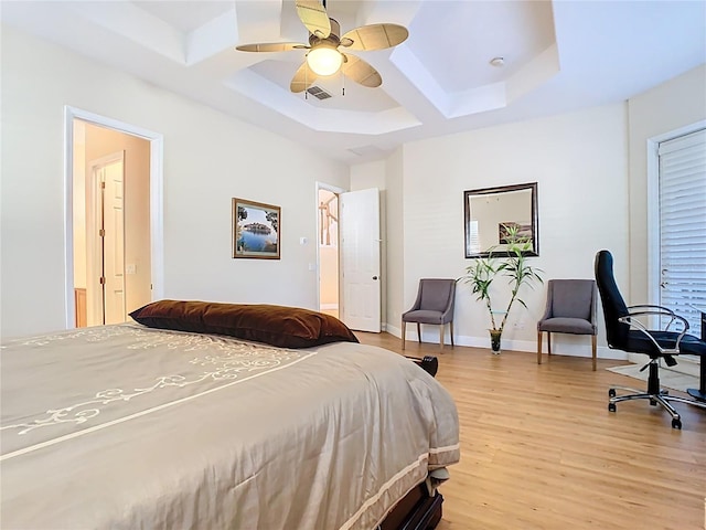 bedroom with light wood finished floors, visible vents, baseboards, a skylight, and coffered ceiling