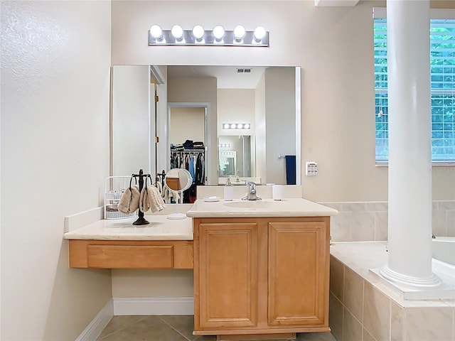 full bath featuring visible vents, a walk in closet, a garden tub, tile patterned floors, and vanity