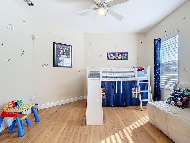 bedroom with visible vents, ceiling fan, baseboards, and wood finished floors