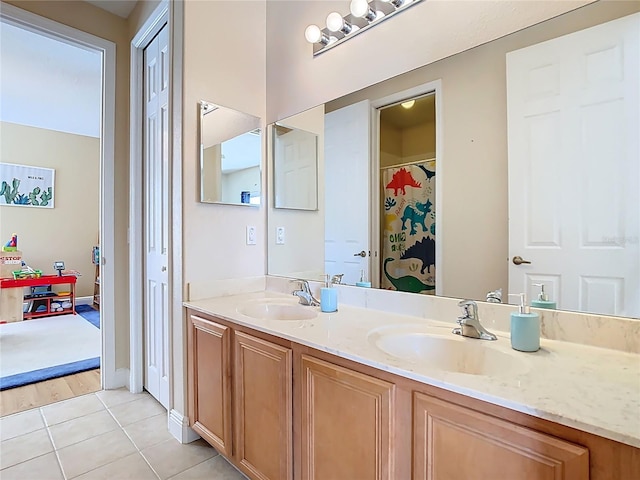 bathroom featuring a sink, double vanity, and tile patterned floors