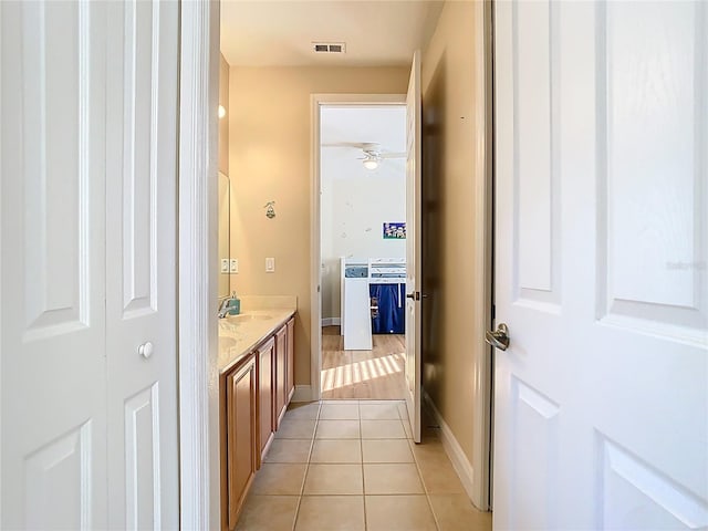 bathroom with tile patterned flooring, visible vents, baseboards, ceiling fan, and vanity