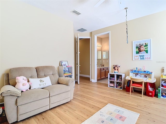 living room featuring visible vents and light wood-type flooring