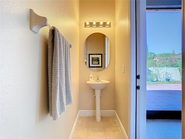 bathroom featuring tile patterned flooring and baseboards