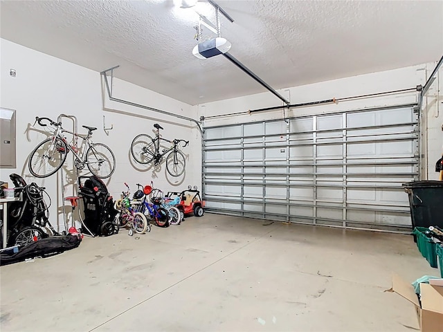 garage featuring electric panel and a garage door opener