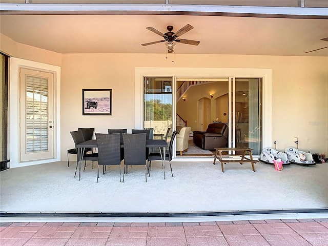 view of patio with outdoor dining space and ceiling fan