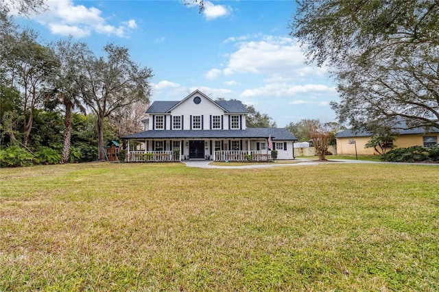 farmhouse-style home with covered porch and a front yard