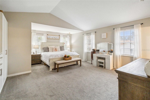 bedroom featuring baseboards, carpet, and vaulted ceiling