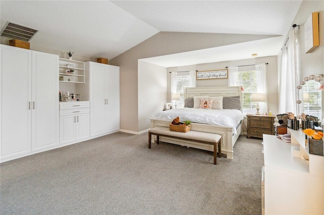 bedroom with visible vents, lofted ceiling, light colored carpet, and baseboards