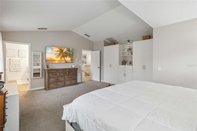 carpeted bedroom with visible vents, lofted ceiling, baseboards, and connected bathroom