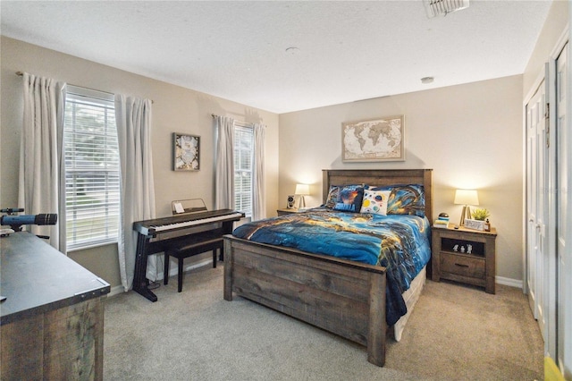 carpeted bedroom with visible vents and baseboards