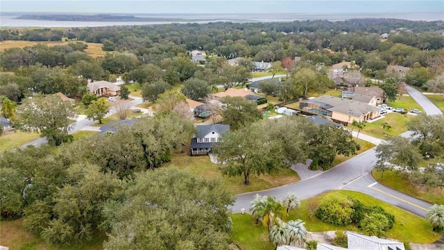 drone / aerial view featuring a residential view and a view of trees