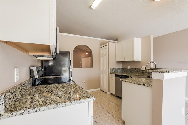 kitchen featuring light tile patterned floors, appliances with stainless steel finishes, a peninsula, arched walkways, and white cabinets