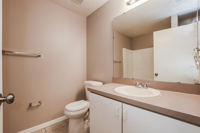 bathroom with vanity, tile patterned floors, toilet, and baseboards