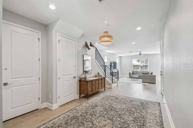 entryway with recessed lighting, stairs, a ceiling fan, and wood finished floors