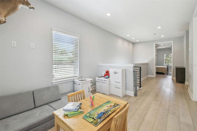 living area with recessed lighting, baseboards, and light wood-style floors