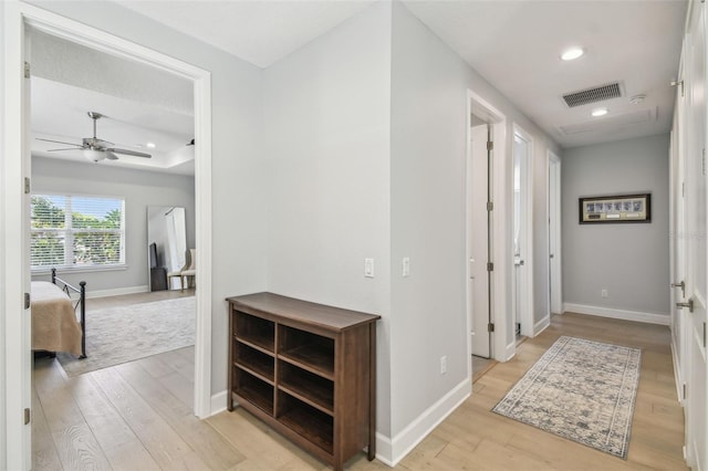 hall featuring recessed lighting, visible vents, light wood finished floors, and baseboards