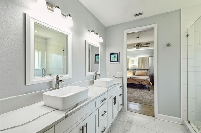 ensuite bathroom with marble finish floor, a stall shower, ensuite bath, and a sink