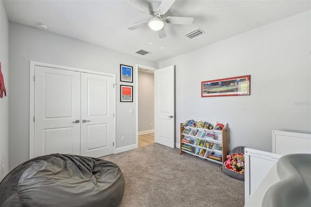 playroom with a ceiling fan, visible vents, carpet floors, and baseboards