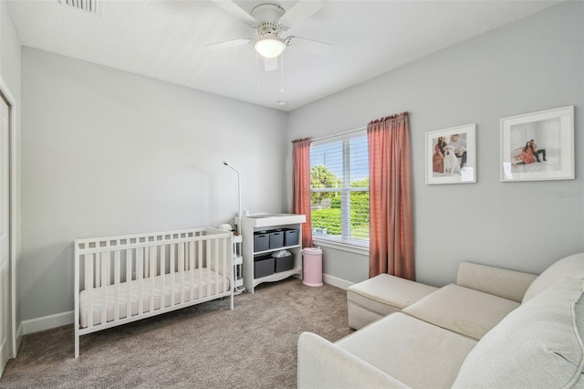 carpeted bedroom featuring visible vents, baseboards, and a ceiling fan