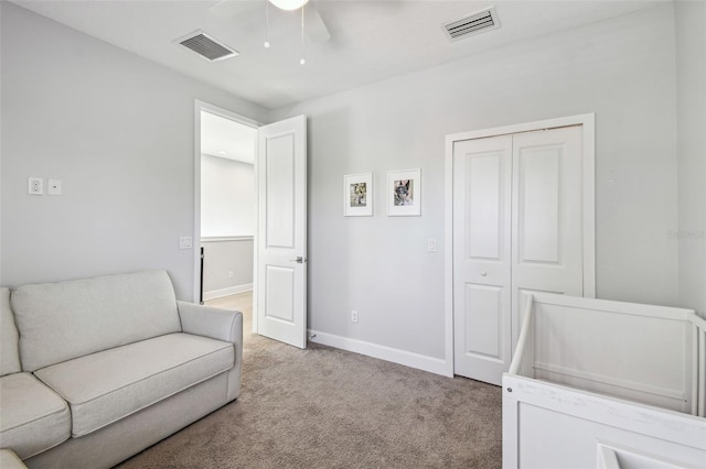 bedroom featuring visible vents, light carpet, baseboards, and a closet