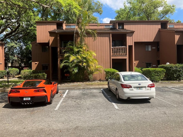 view of property featuring uncovered parking