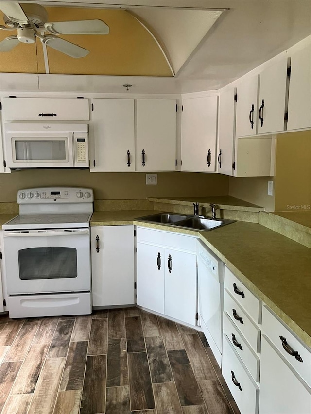 kitchen with white appliances, wood tiled floor, ceiling fan, a sink, and white cabinets