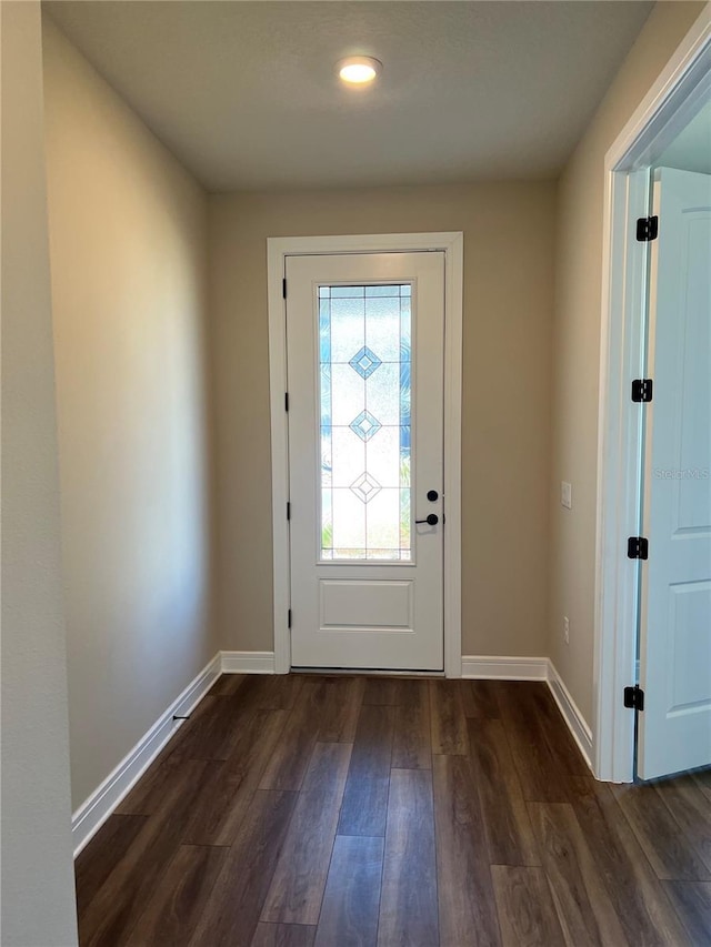 foyer entrance with baseboards and dark wood-style flooring